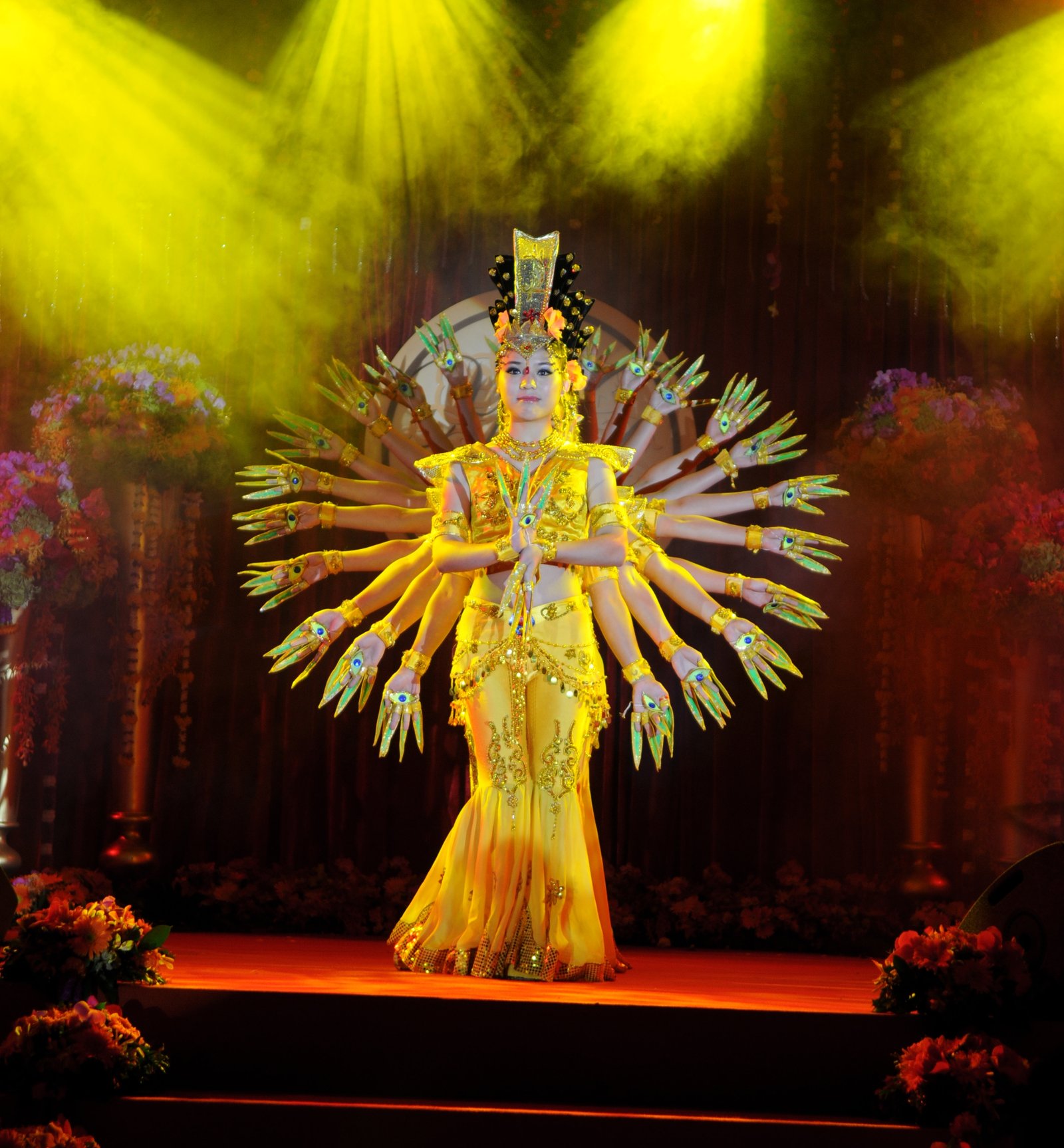 Portrait of Ravi Wadje, middle-aged man with glasses, gray beard, wearing a light gray pinstripe suit, black shirt and patterned tie, professional studio photo